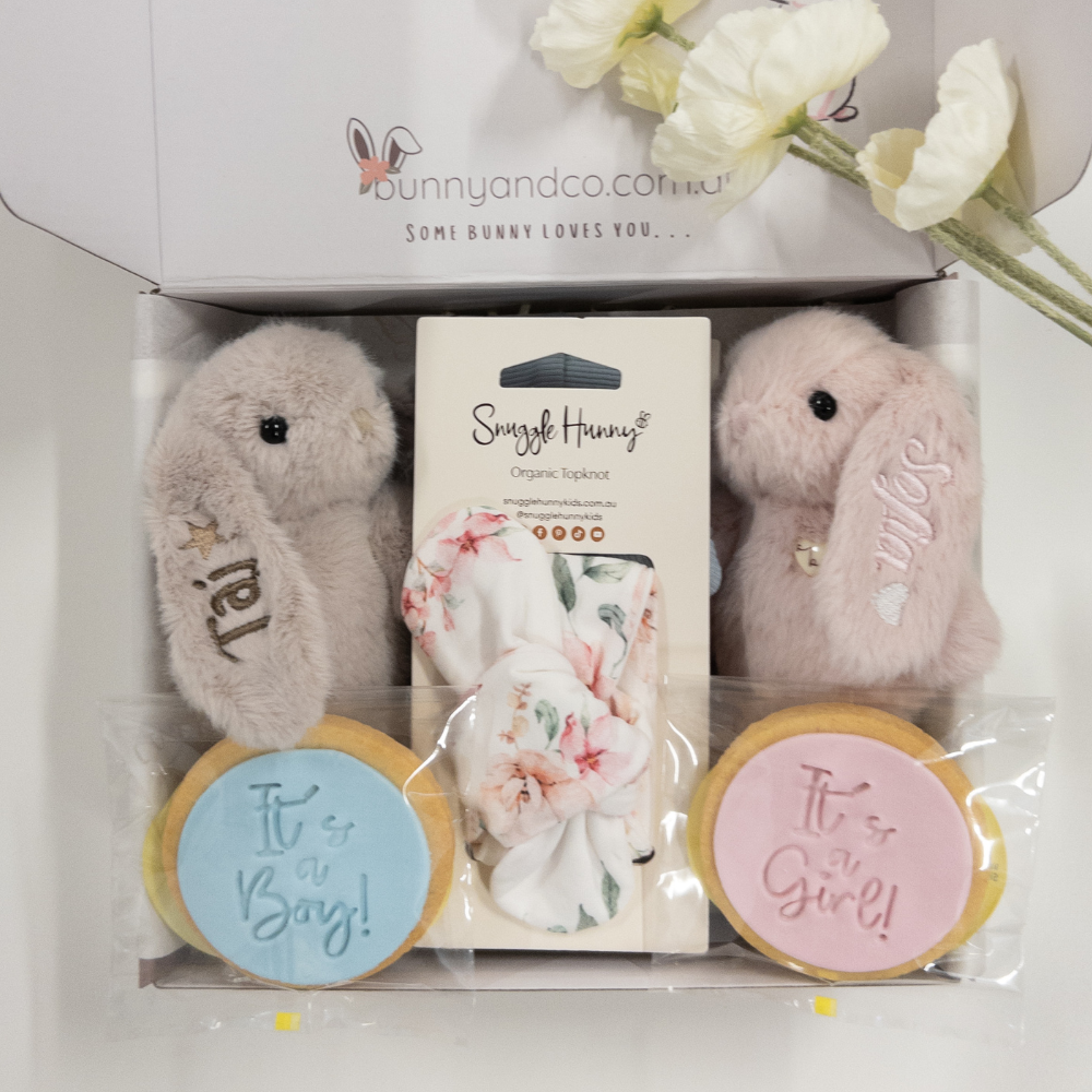 Twin baby gift hamper boy and girl  with pesonalised plush bunny toys and baby announcement items in a box, featuring bunnyandco.com branding.
