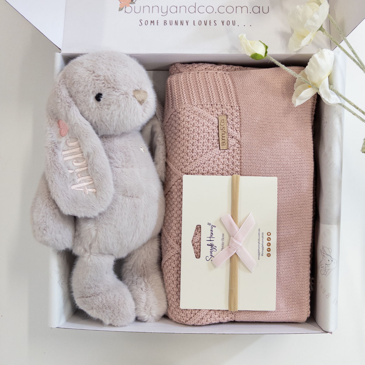 Gift set with plush personalised bunny and pink diamond knit blanket in a box, featuring 'bunnyandco.com.au' branding.