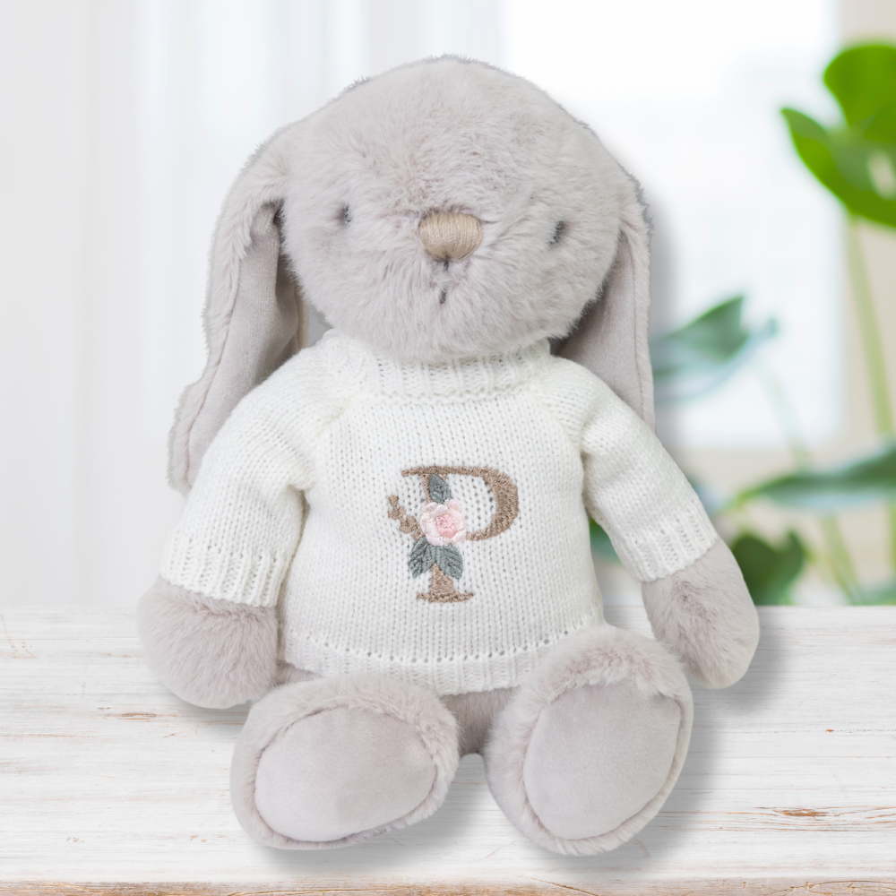 Jamie Kay bunny wearing white cream jumper with letter initial on front