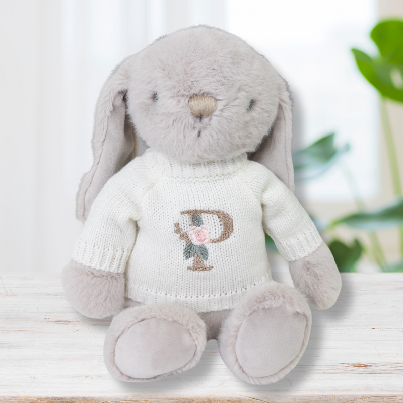 Jamie Kay bunny wearing white cream jumper with letter initial on front