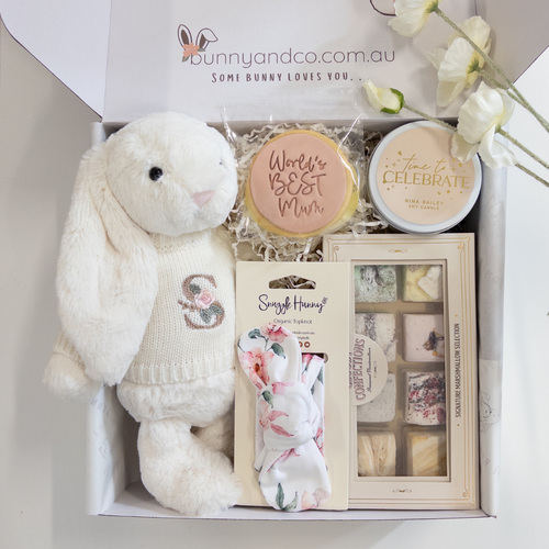 Gift set with plush Jellycat Bunny toy, cookies, and babyand new mum items in a box with bunnyandco.com.au branding.