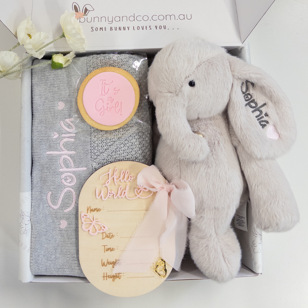 A personalised baby gift with baby blanket, personalised elephant teddy, birth announcement plaque and It's a Girl cookie