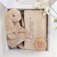 Baby gift set with plush bunny, blanket, and 'World's Best Mum' badge in a box.