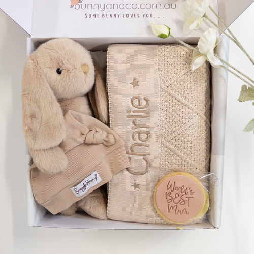 Baby gift set with plush bunny, blanket, and 'World's Best Mum' badge in a box.