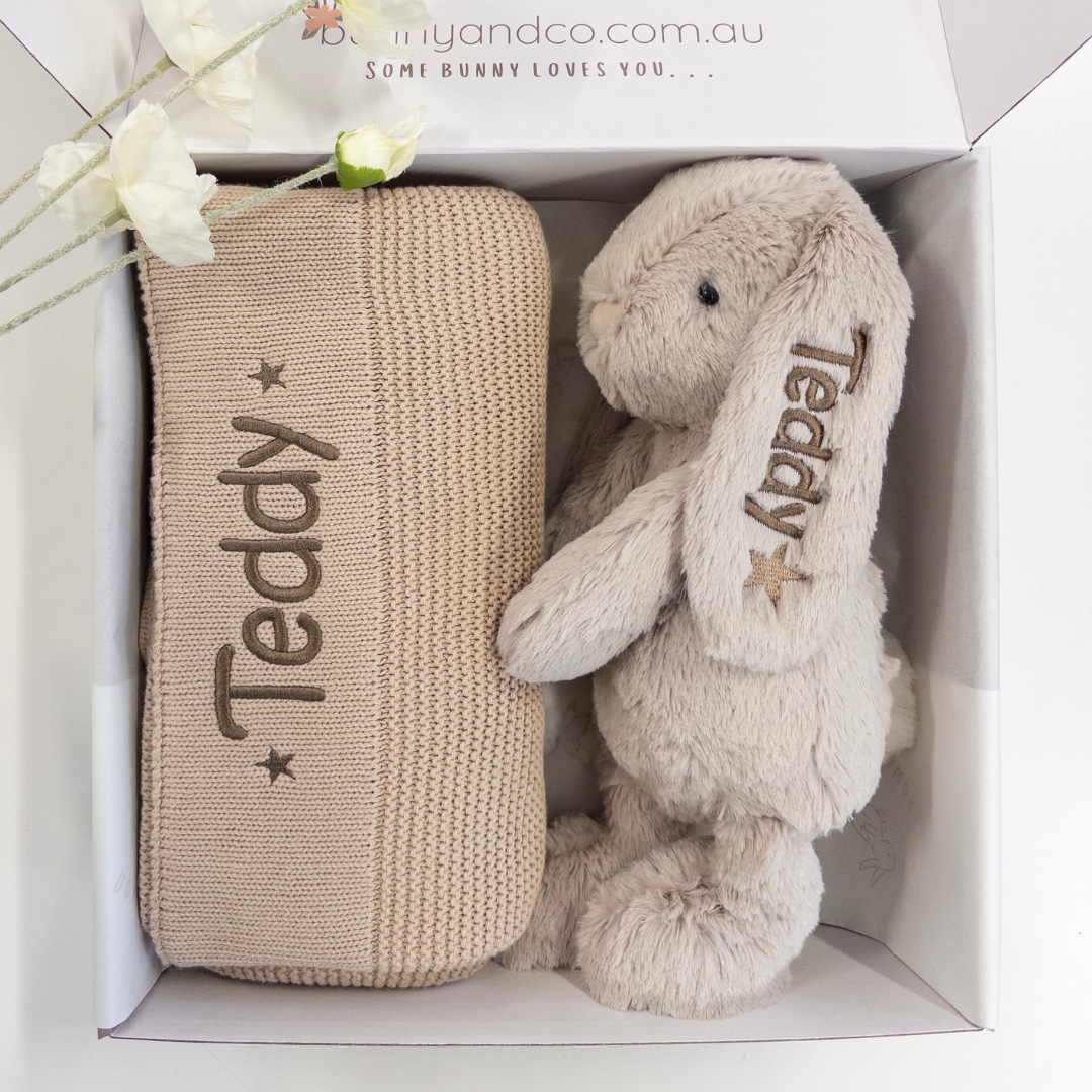 Beige knitted blanket and plush bunny toy for baby with 'Teddy' embroidery in a box, brand 'bunnyandco.com.au' visible.