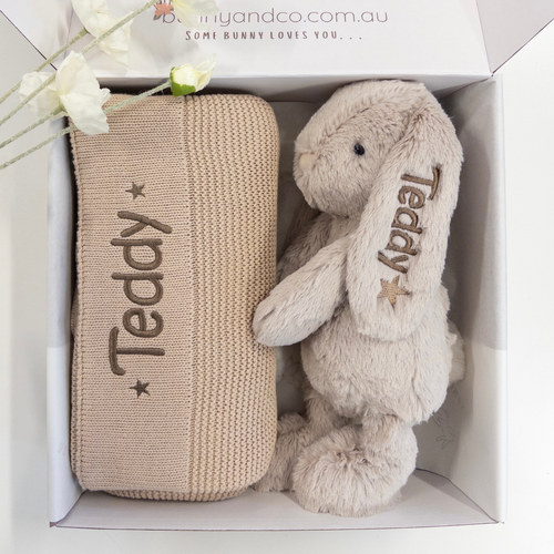 Beige knitted blanket and plush bunny toy for baby with 'Teddy' embroidery in a box, brand 'bunnyandco.com.au' visible.