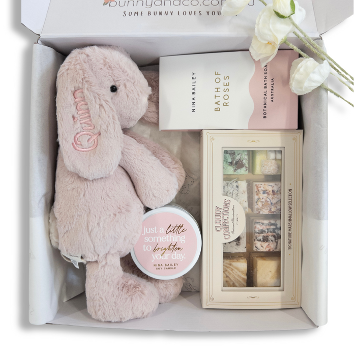 Personalised newborn baby gift hamper basket australia featuring personalised blush Snuggle Bunnies jamie kay, Nina Bailey and Cloudy Confections marshmallows. 