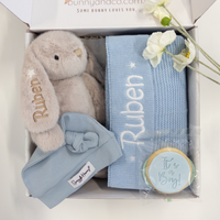 Baby gift set with plush bunny, blanket, and cookie in a box