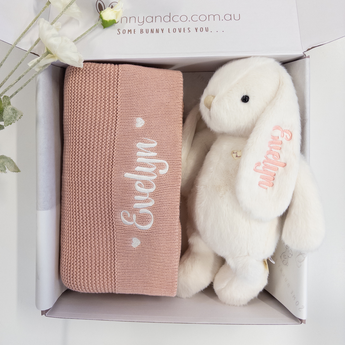 baby girl Gift set with pink knitted blanket and white personalised bunny plush toy in a box, featuring 'Evelyn' on the toy.