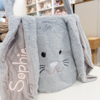 Grey plush easter bunny basket bag with 'Sophie' on a white surface